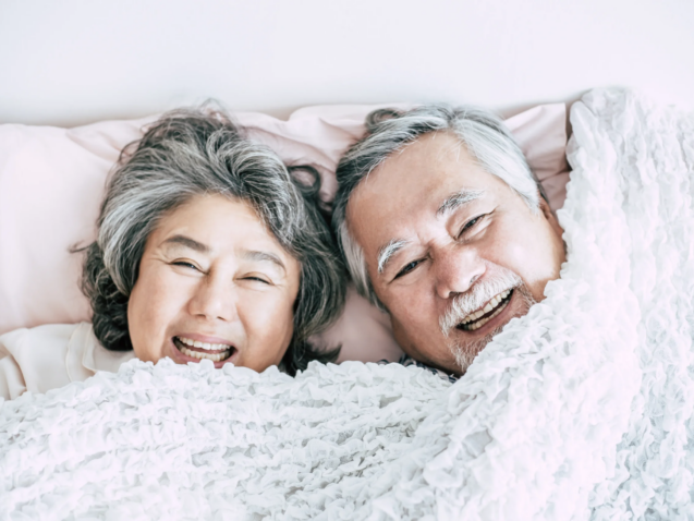 happy-senior-couple-laughing-in-bed-together-2026-01-07-00-55-39-utc